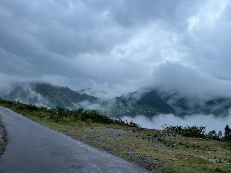 High-altitude land with mountain and cloud views