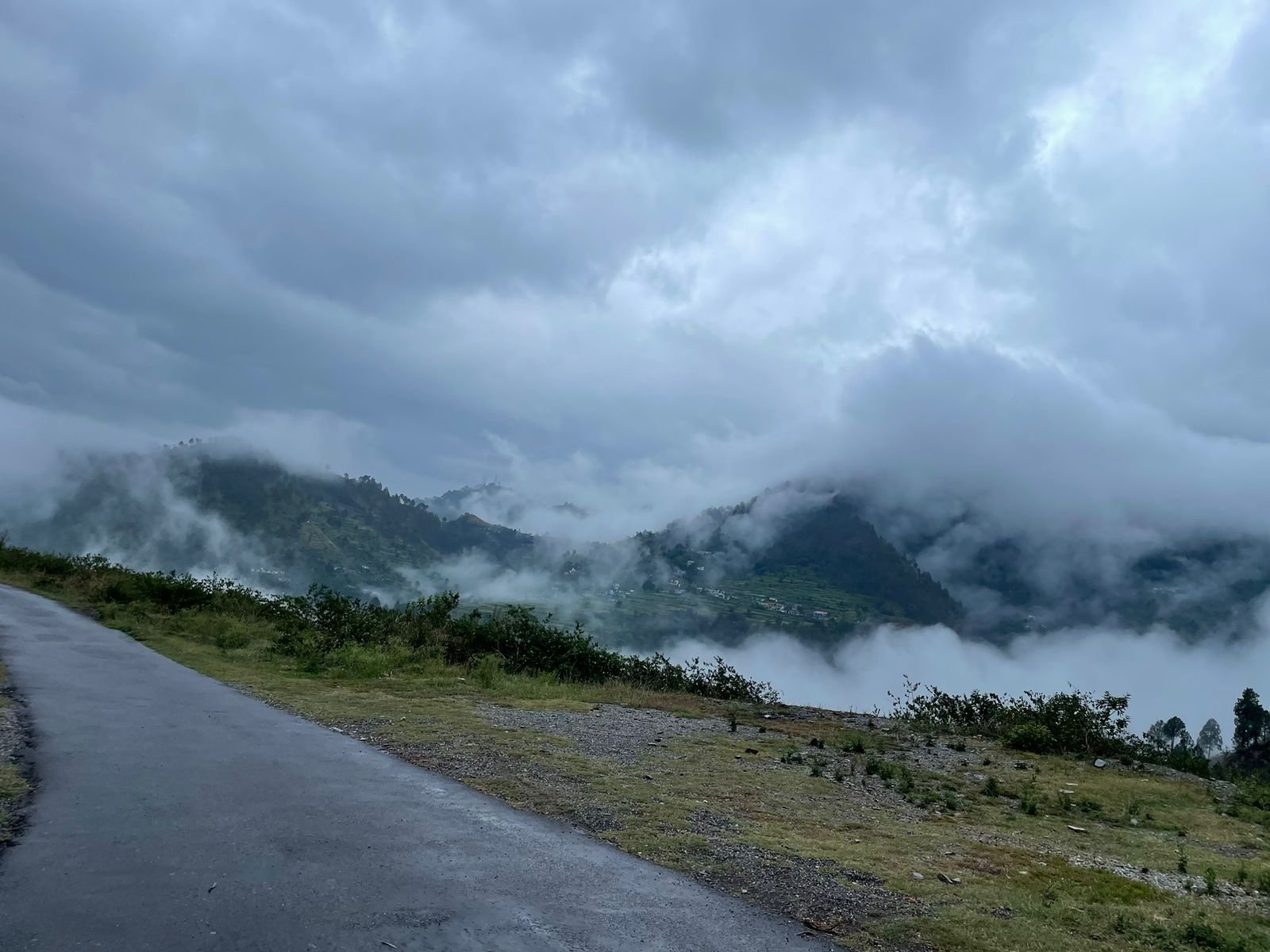 High-altitude land with mountain and cloud views